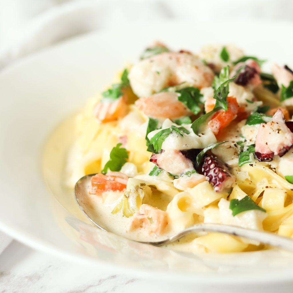 Rich, creamy pasta alfredo with octopus, squid and shrimp