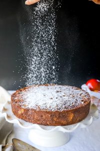 Sprinkling powdered sugar on apple cake is an easy way to decorate