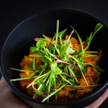 Vegetarian Pea Microgreen Salad On Carrot Risotto