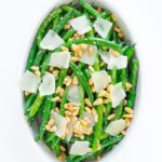 Garlic butter green beans in a white dish