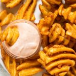 Sweet potato fries with pink spicy mayo dipping sauce.