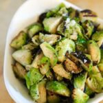 White bowl of pan roasted brussels sprouts.