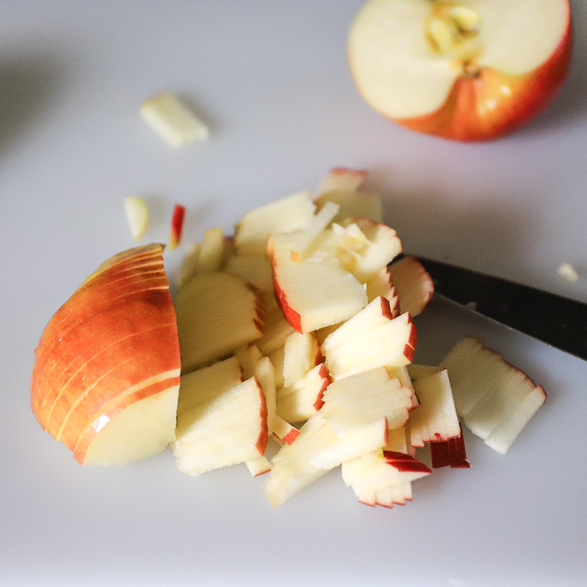 The half sliced apple is now sliced crossways making it into thin fine pieces for the salad.