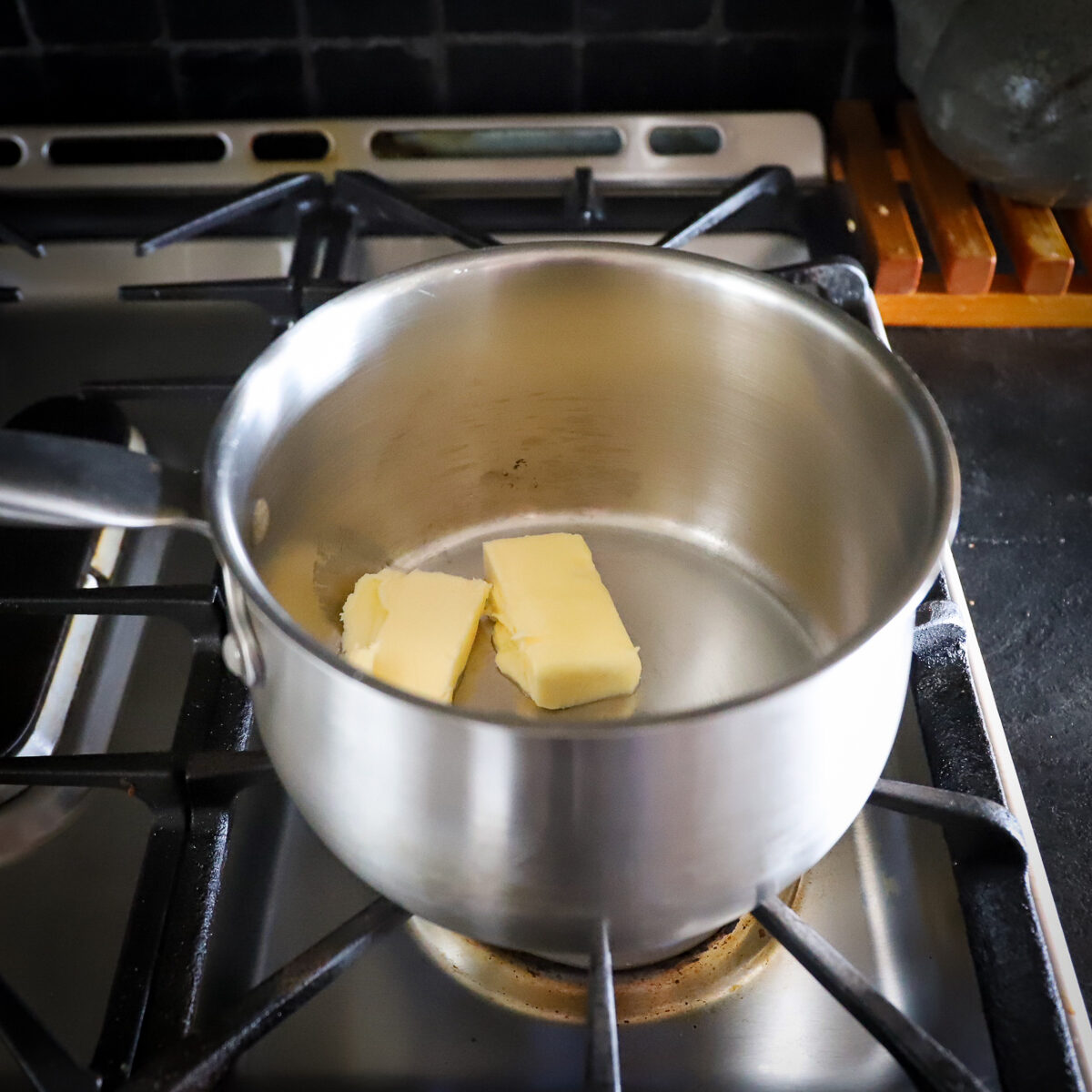 Butter in stainless steel pot.