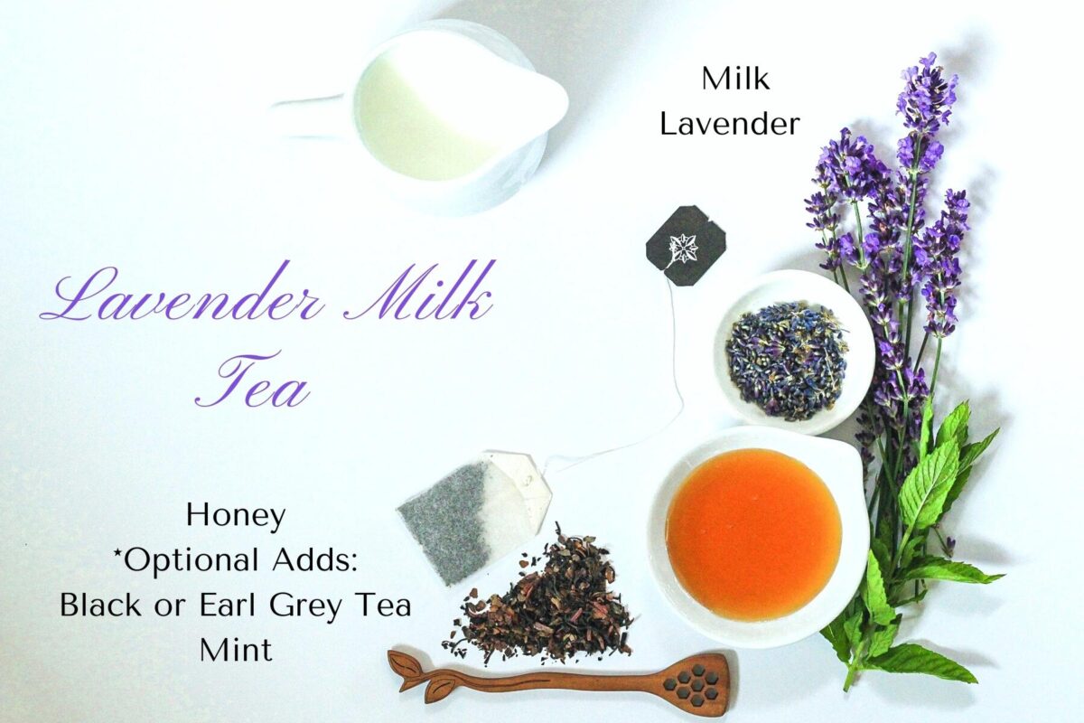 Overhead shot of the ingredients for the lavender milk tea. There is a pitcher of milk, sprigs of lavender and mint, a dish of honey, a dish of lavender buds, loose black tea, a tea bag and a honey spoon.