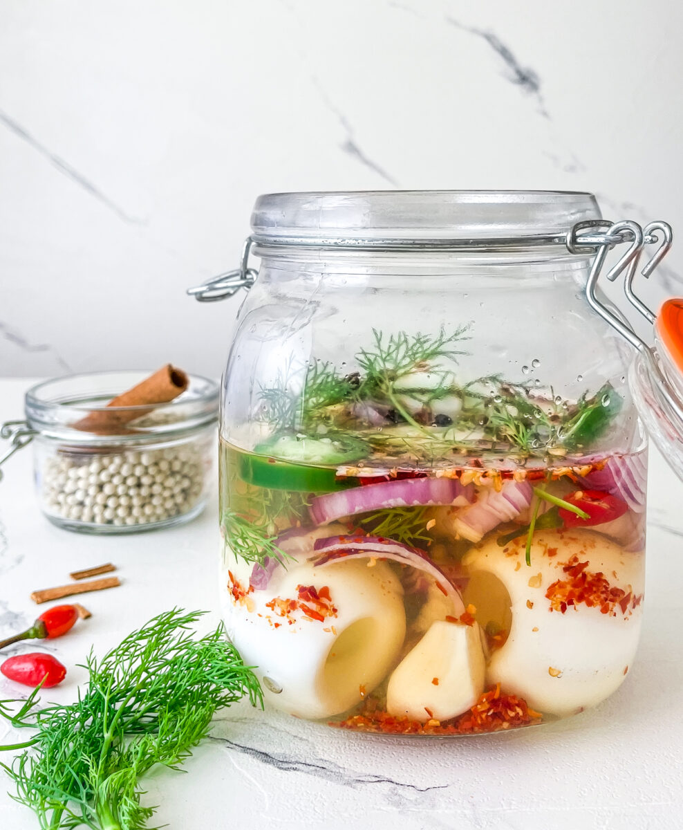 Eggs, spices and herbs are all submerged in the pickling brine.