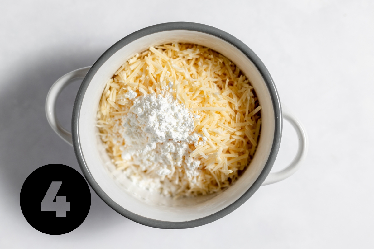 In a separate small pot, flower is added to the shredded Parmesan cheese.