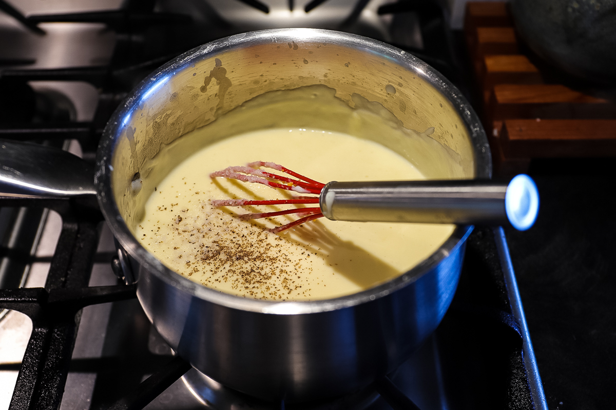 Sauce is creamy and smooth, pepper is sprinkled on top.
