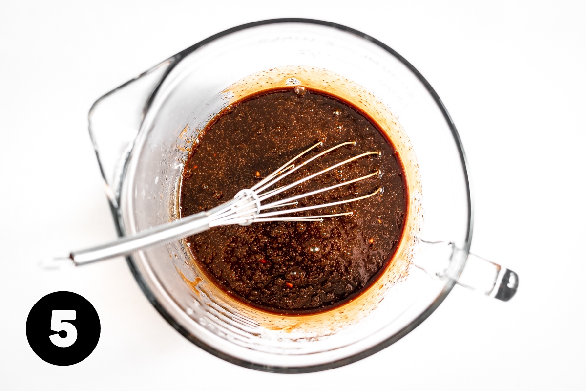 Wet ingredients in a measuring cup are all mixed together and a dark brown color now.