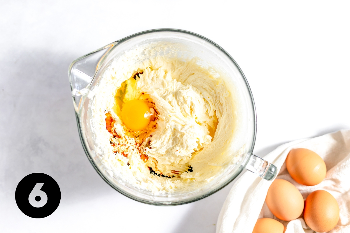Eggs have been cracked into the mixing bowl on top of the creamy mixture.