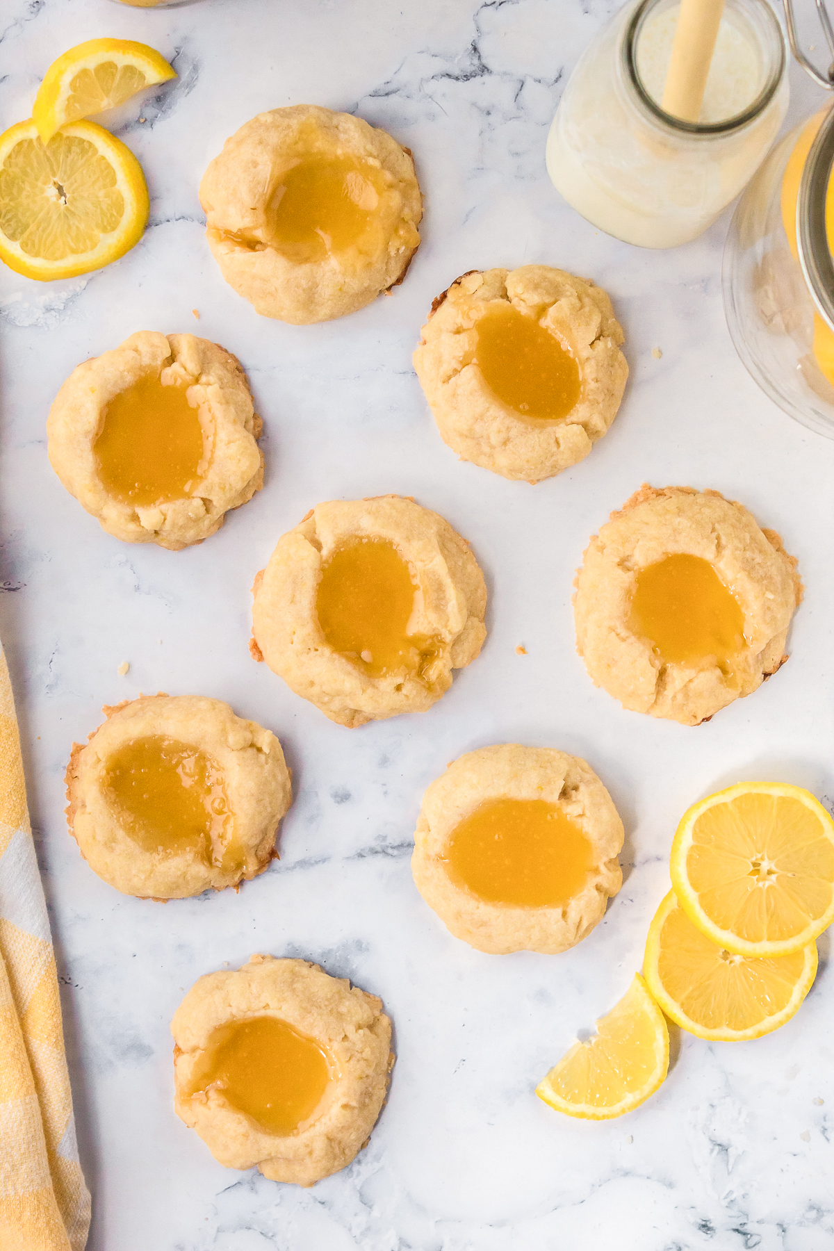 A white countertop with evenly spaced out lemon cookies.
