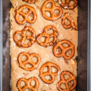 Overhead shot of the uncut pan of no bake peanut butter fudge topped with pretzel twists.