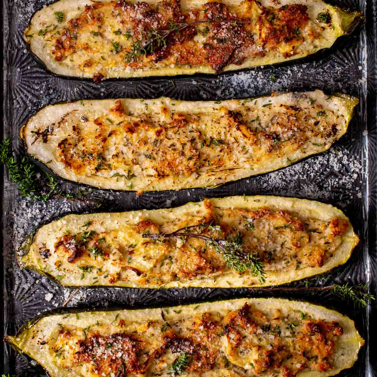 Stuffed zucchini boats that are golden brown and crispy on top.