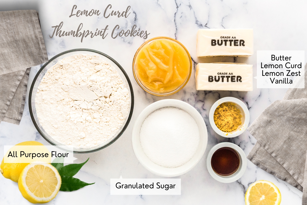 Labelled ingredients for lemon cookies. Shown is butter, flour, lemon curd, sugar, lemon zest and vanilla extract.