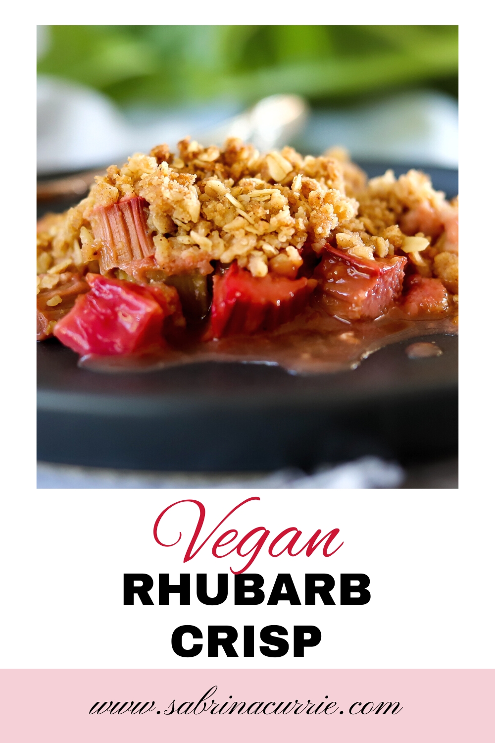 Pinterest graphic with photo of bright pink and golden brown vegan rhubarb crumble with green rhubarb leaf in the background.