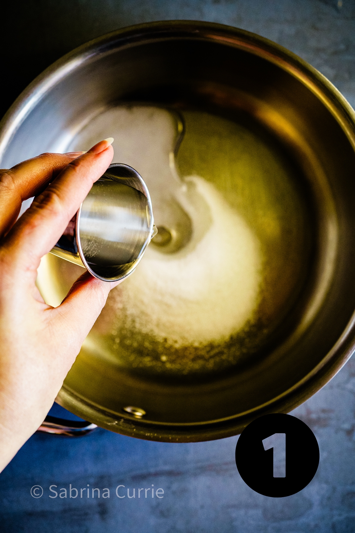 Step 1: Combining water and sugar in a saucepan to make simple syrup. 