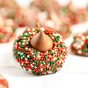 Chocolate cookies rolled in red, white and green sprinkles and topped with chocolate Hershy kiss candies.