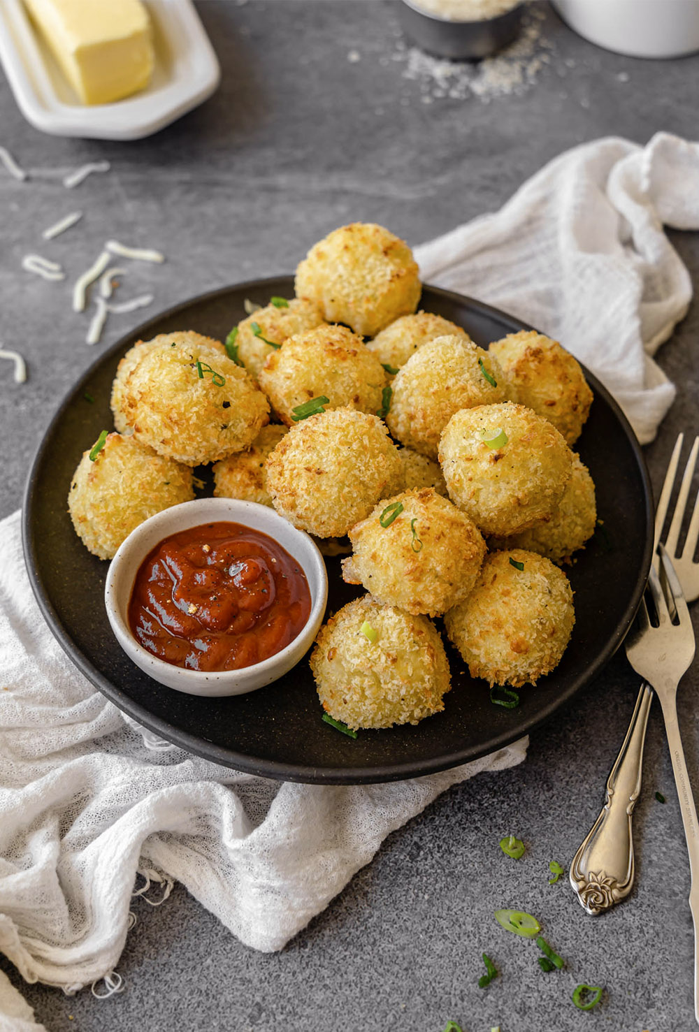 Round, golden brown potato croquettes with a side of ketchup.