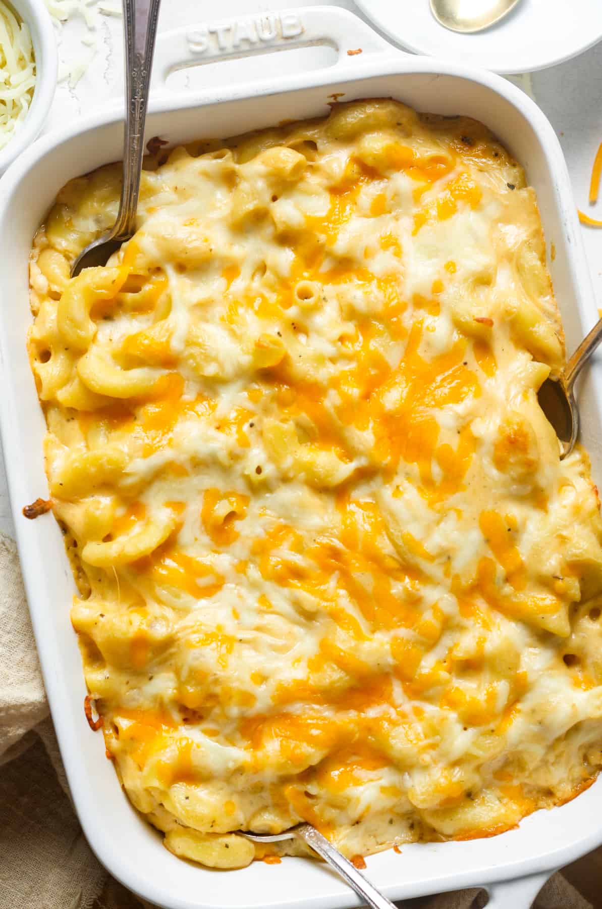 White casserole dish with baked macaroni and cheese.
