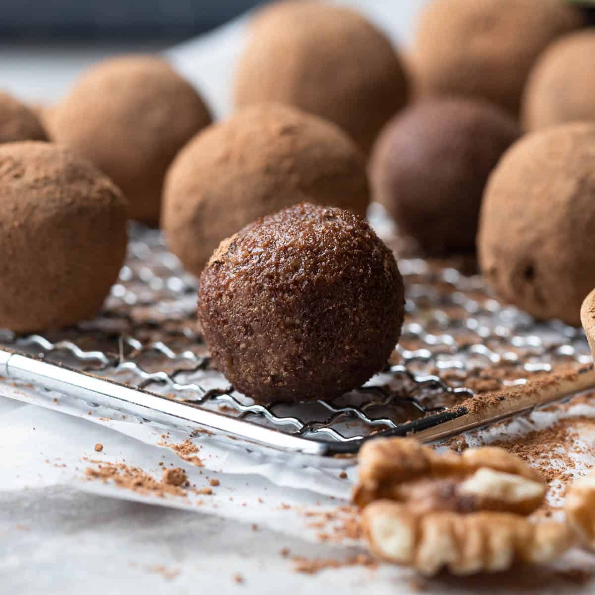 Brown energy balls dipped in cocoa powder.