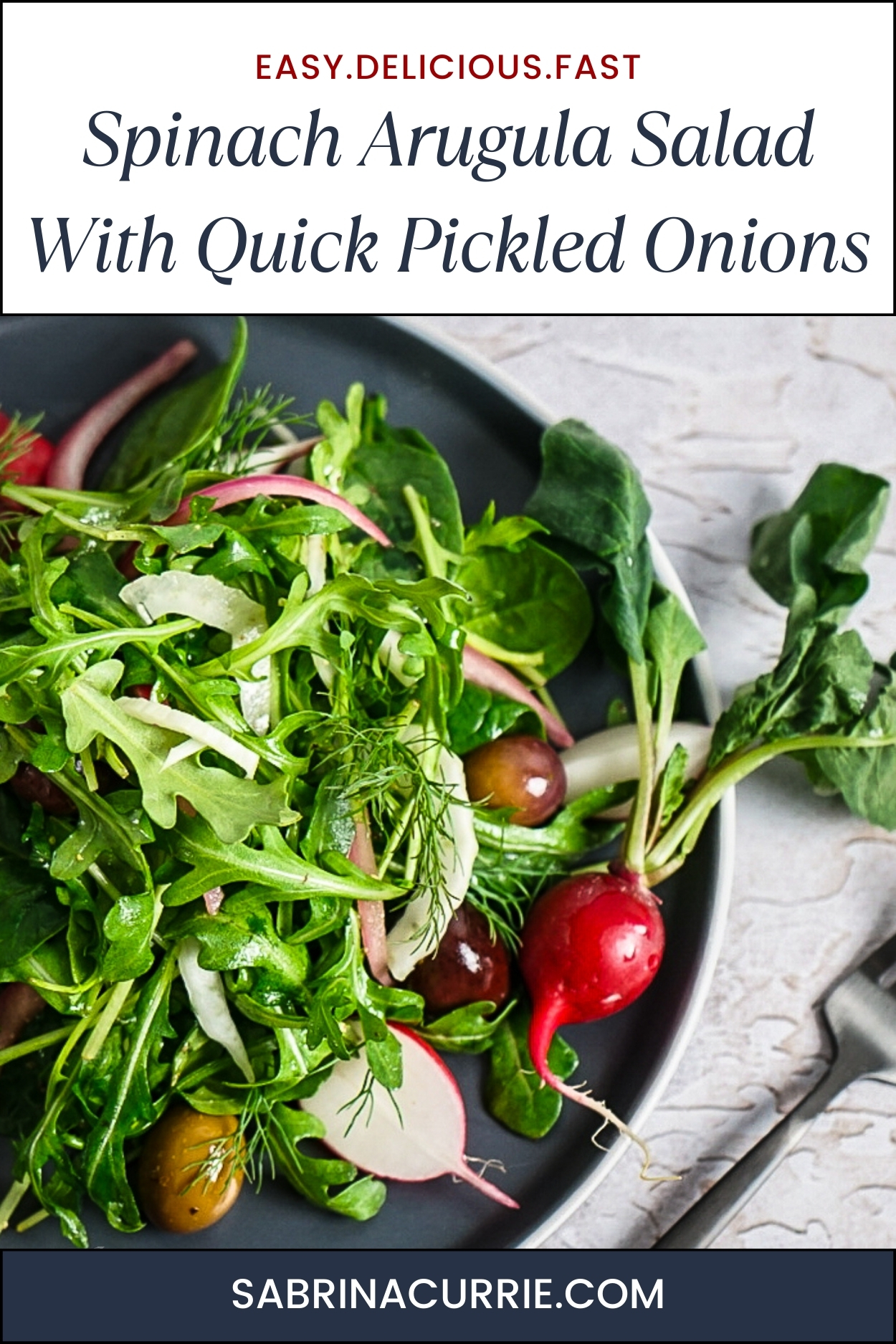 Tall graphic with recipe title at the top and green spinach and arugula salad with sliced radishes, red onions and slivered fennel on a dark grey-blue plate.