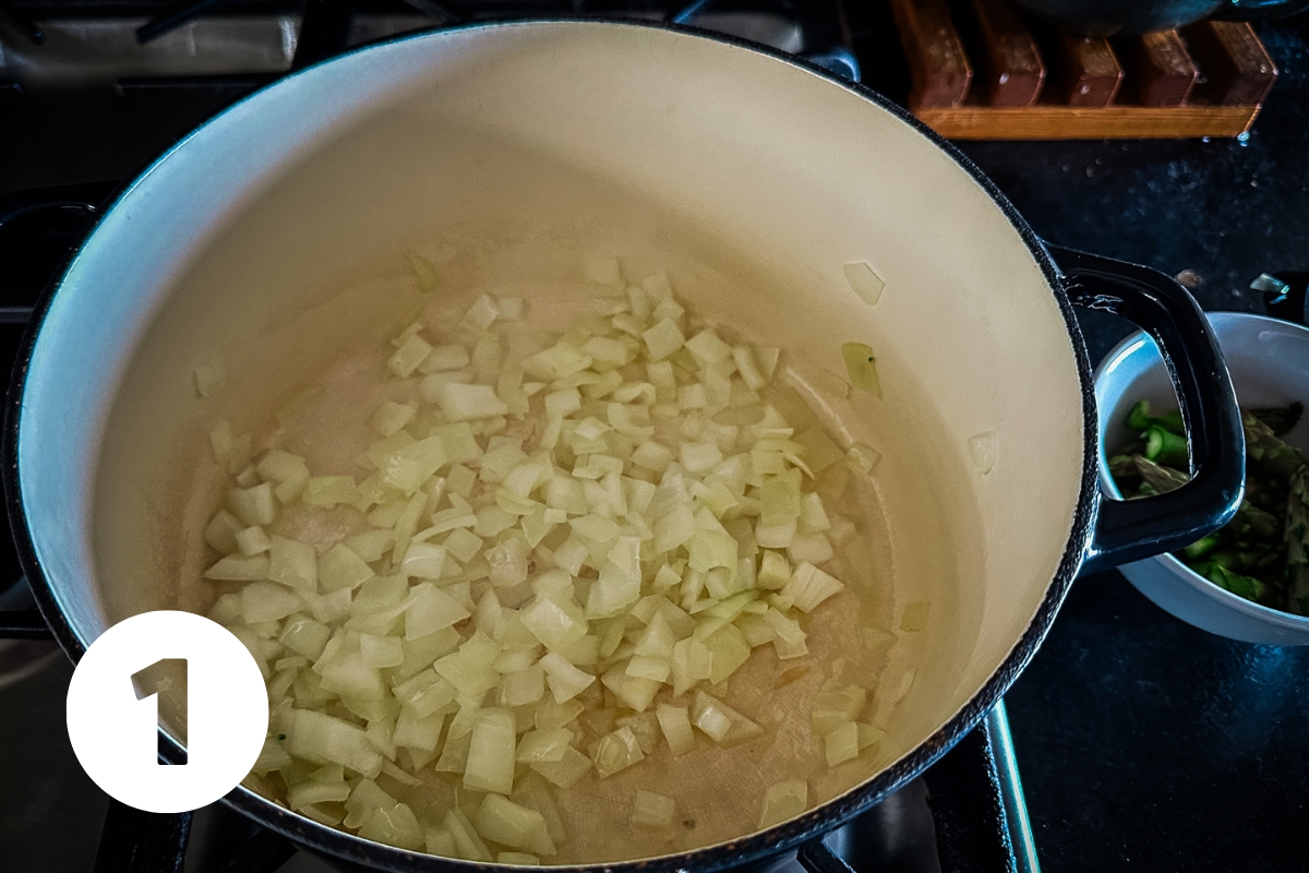 Chopped yellow onion in a soup pot.