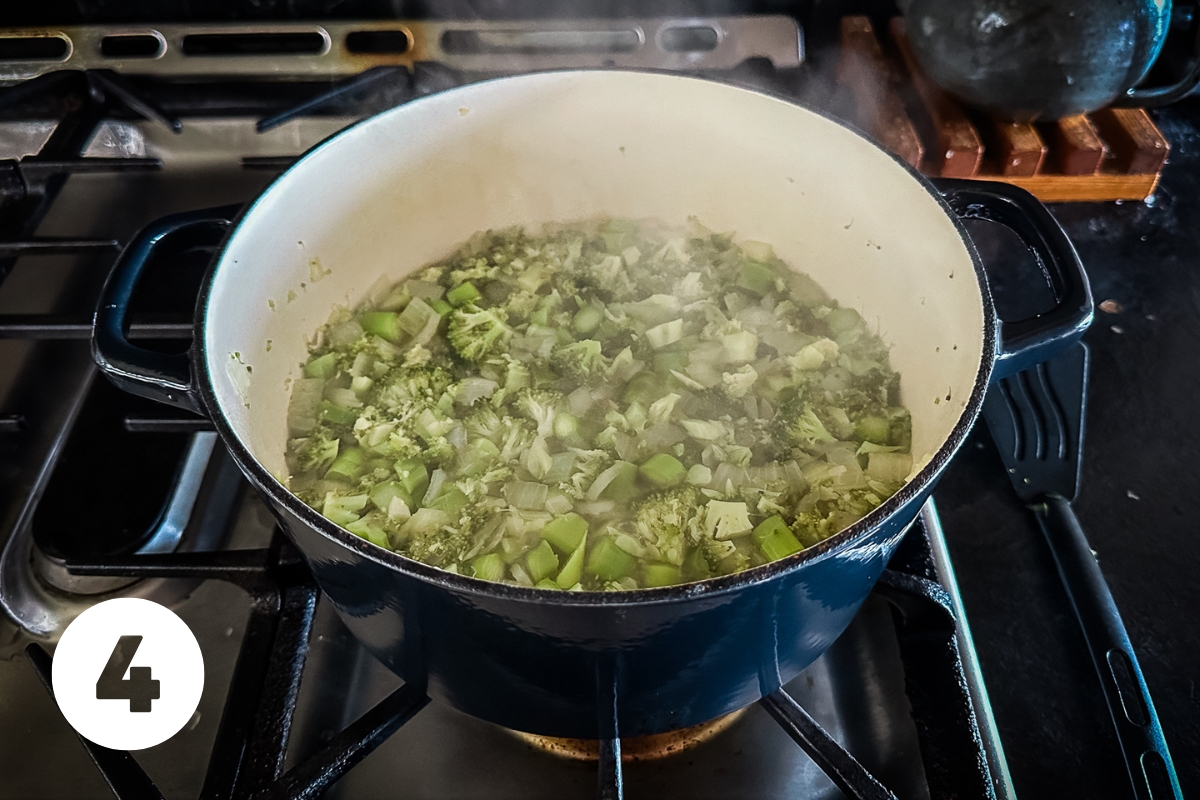 The veggies are now a dull army green color as they simmer in the pot. Steam is rising.