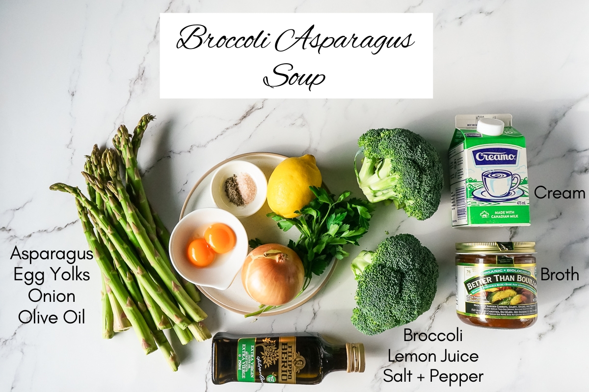 Ingredients for the broccoli asparagus soup. Shown are asparagus spears, 2 egg yolks, a lemon, an onion, olive oil, salt and pepper, broccoli, cream and a jar of vegetable stock mix.