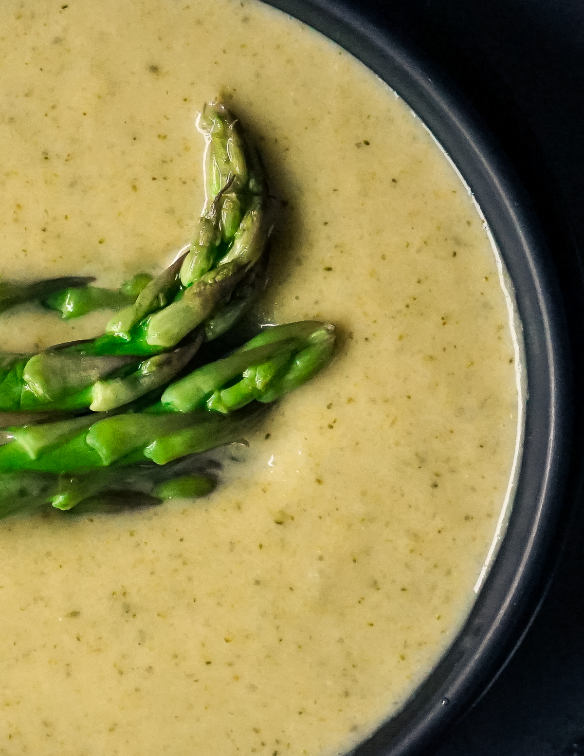 Bright green asparagus topped yellow soup.