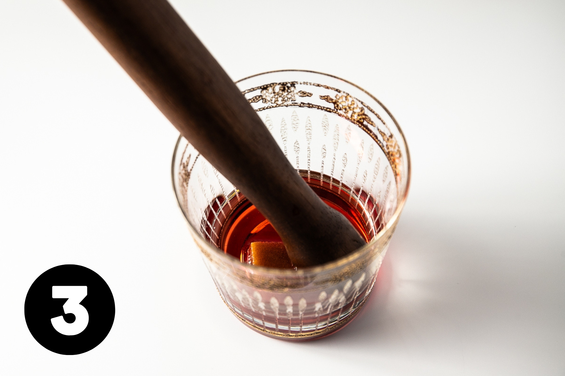 Muddling the cocktail.