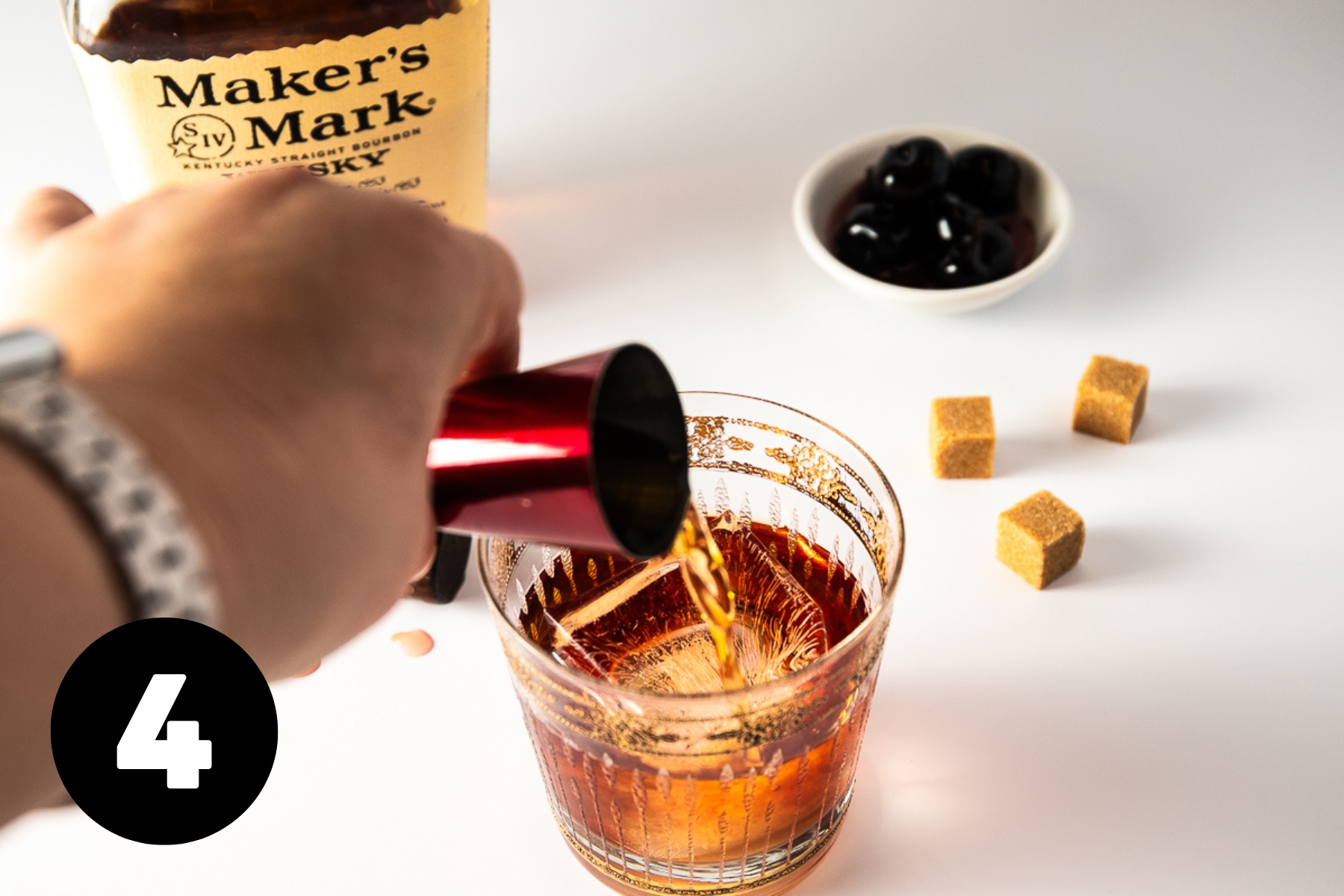 Adding the bourbon from a shot measure.