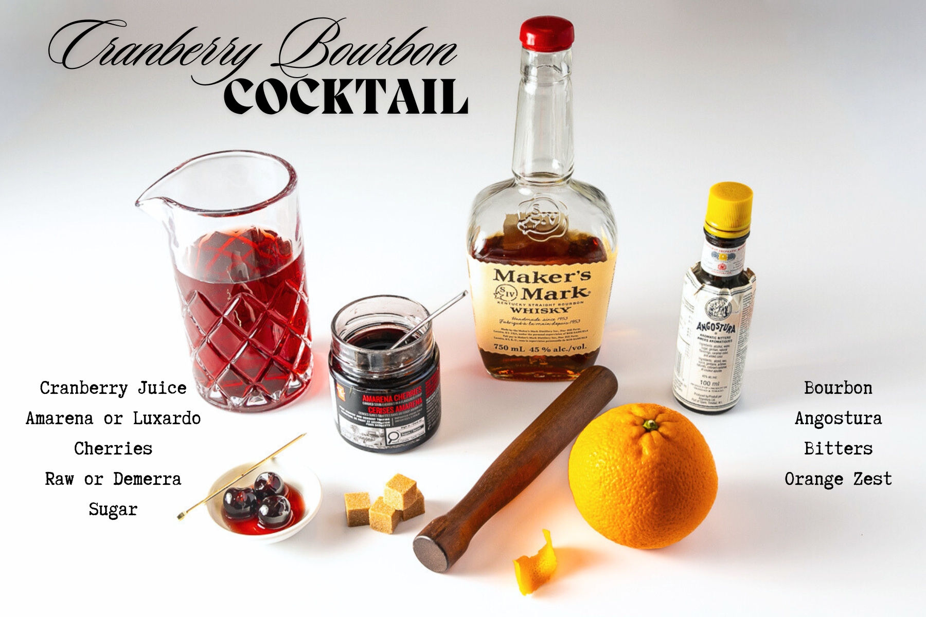 Ingredients for the cocktail on a table including a bourbon, cranberry juice, Angostura bitters, an orange, Amarena cherries, brown sugar cubes and a muddler.