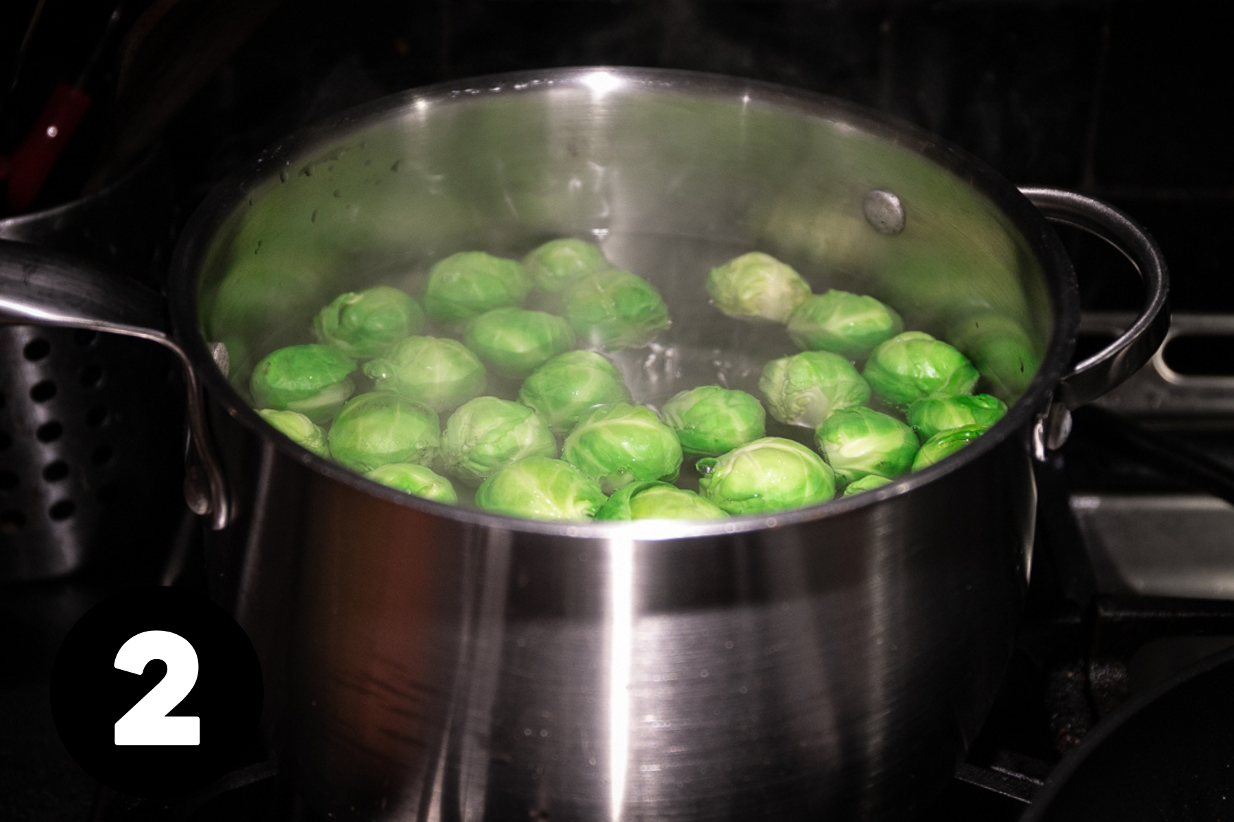Brussels sprouts in a pot of boiling water.
