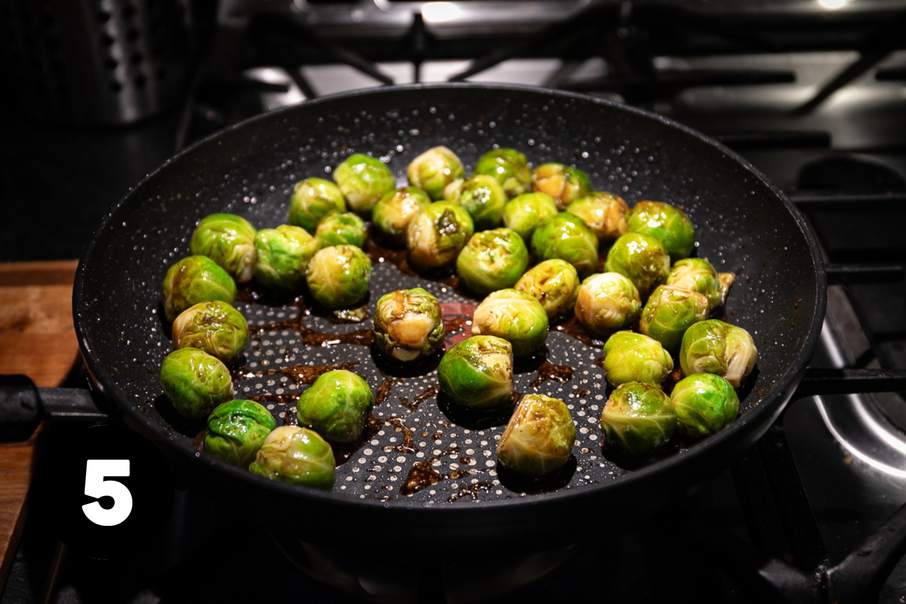 Dark glaze in a frying pan with the Brussels sprouts.