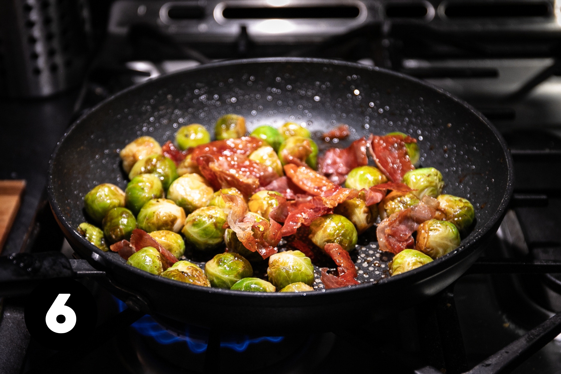 Sprouts and prosciutto in a large skillet.