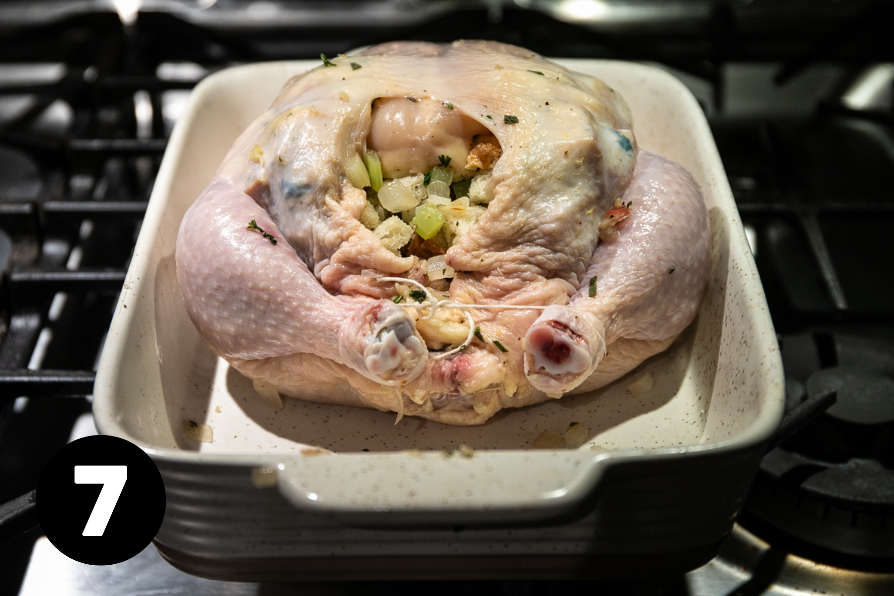 The chicken legs are tied together with cotton twine holding the stuffing in place.