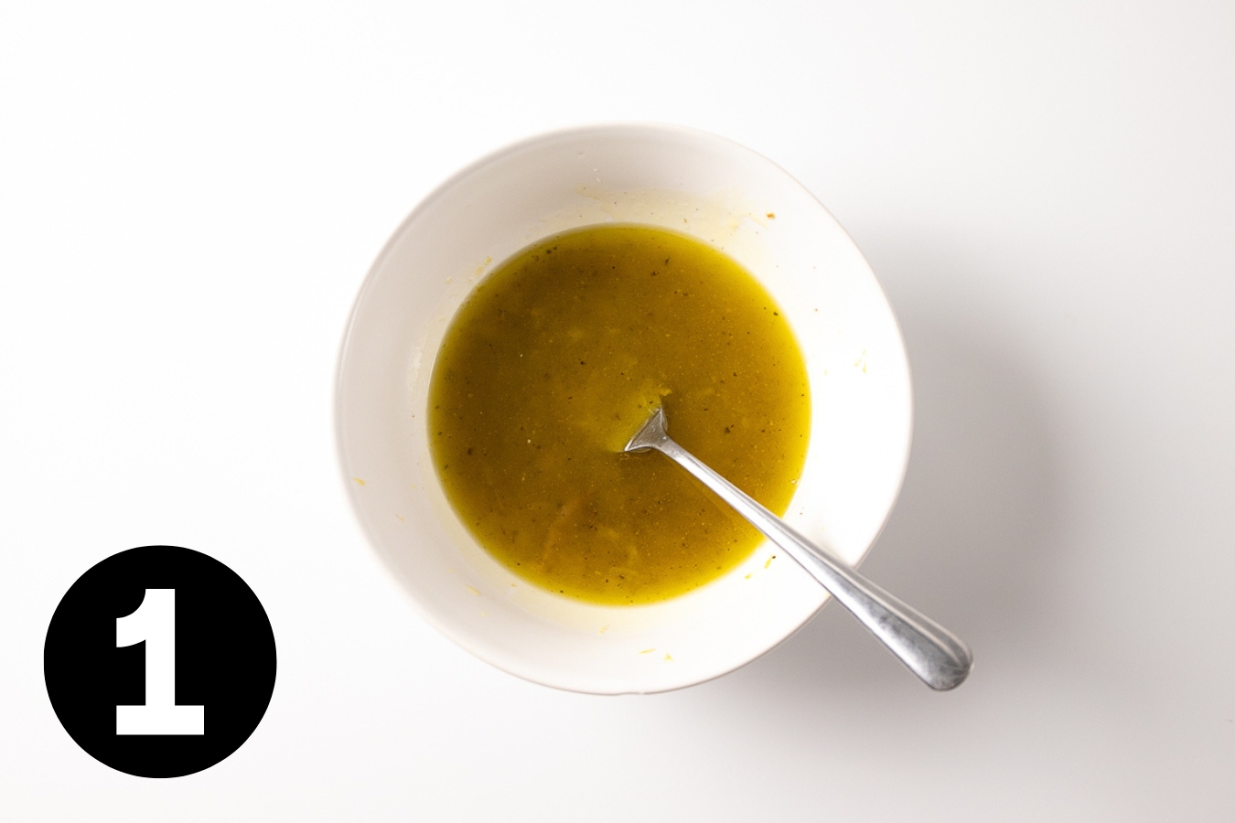 A bowl of olive oil and lemon juice.