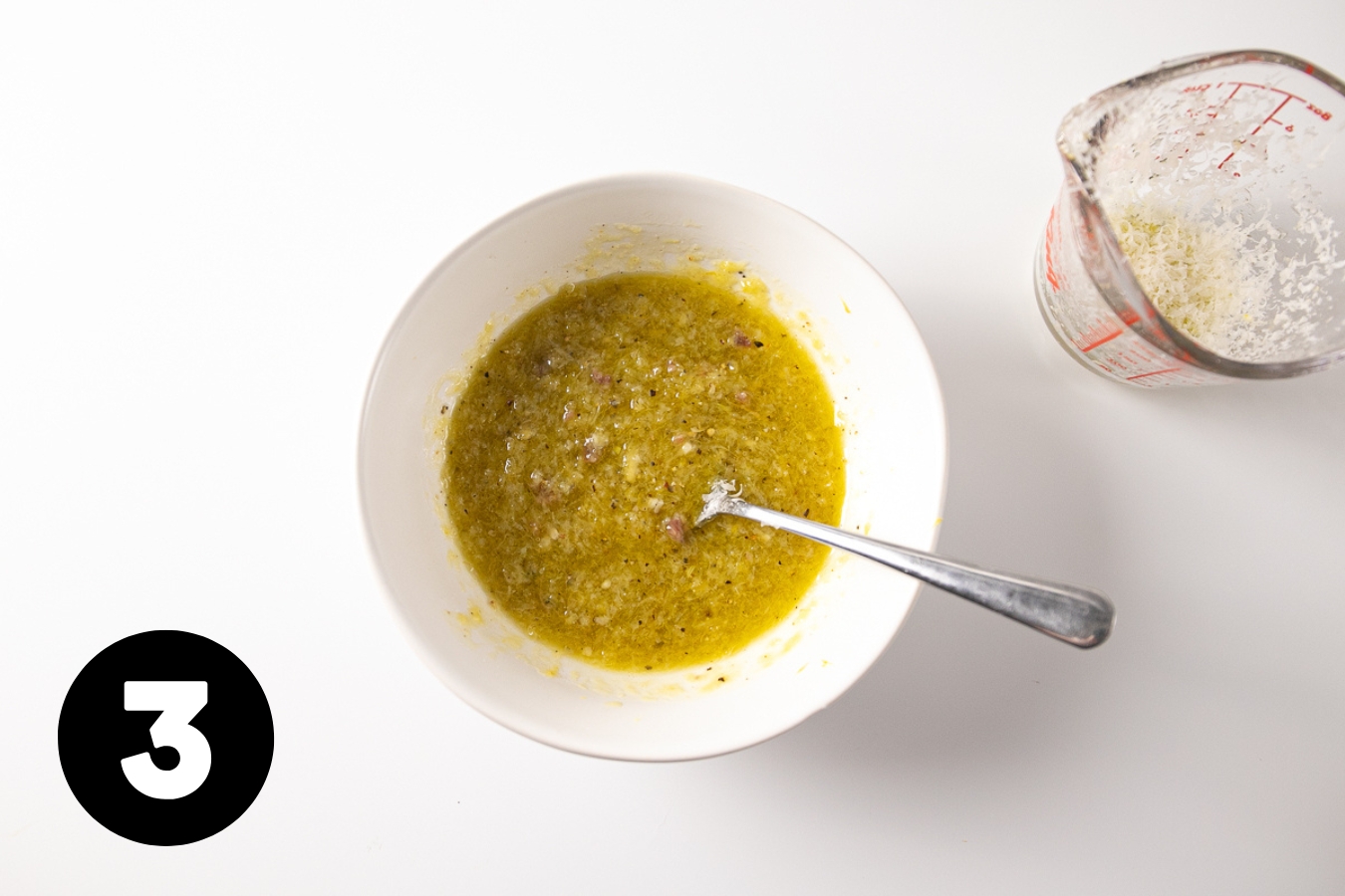 Vinaigrette stirred up in a bowl with a spoon in it.