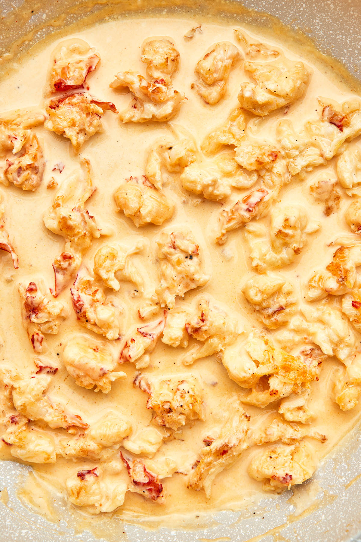 Chunks of lobster in a pale pink cream sauce.