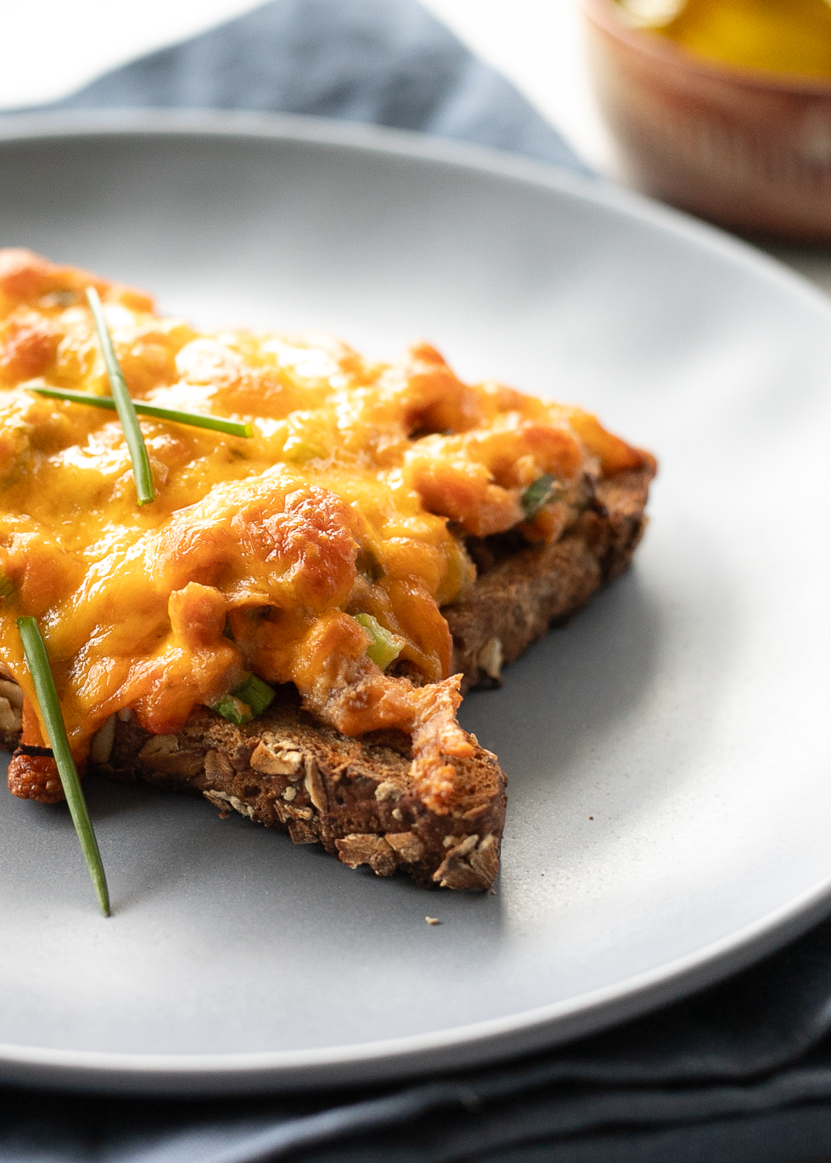 Bubbly, cheese salmon melt topped with some chives.