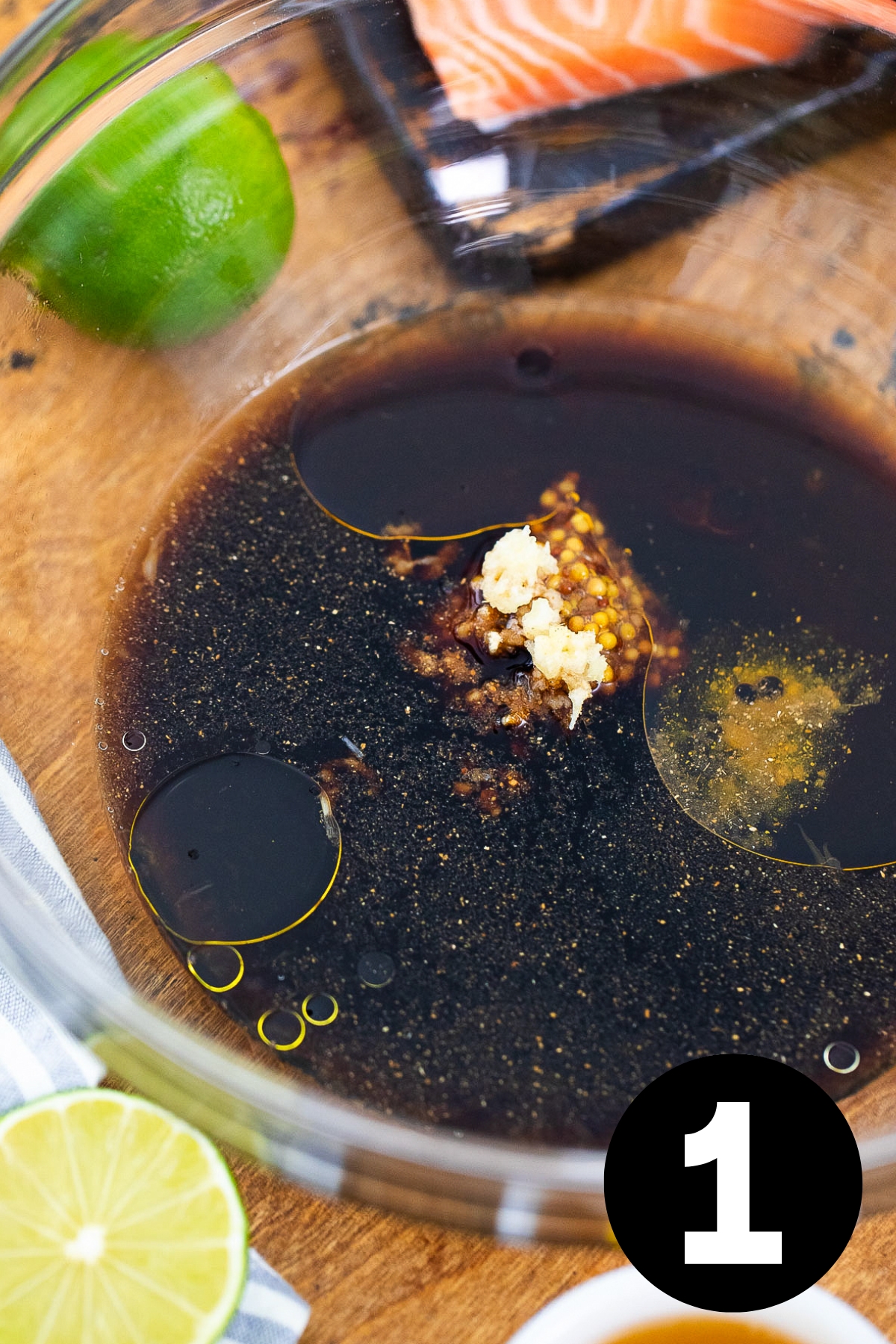Soy sauce based marinade in a glass bowl.
