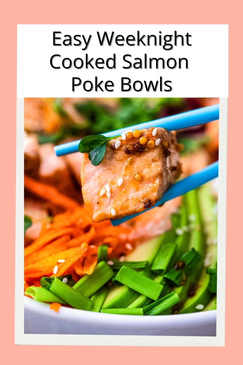 A pair of chopsticks holding up a cube of salmon above the finished poke bowl. 