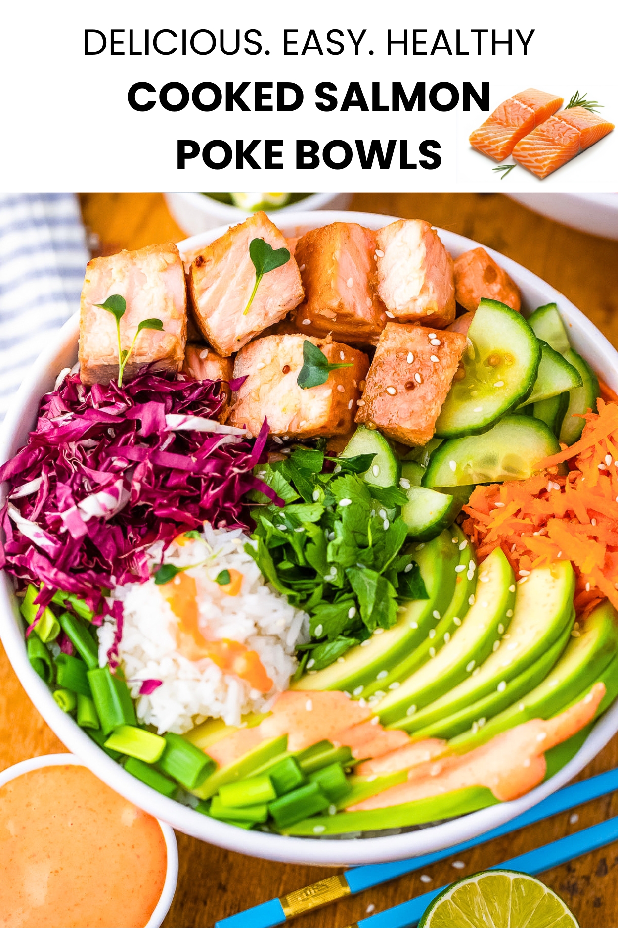 A bowl of cubed cooked salmon, shredded cabbage and carrot, sliced cucumbers and sliced green onions topped with a drizzle of spicy mayonnaise.