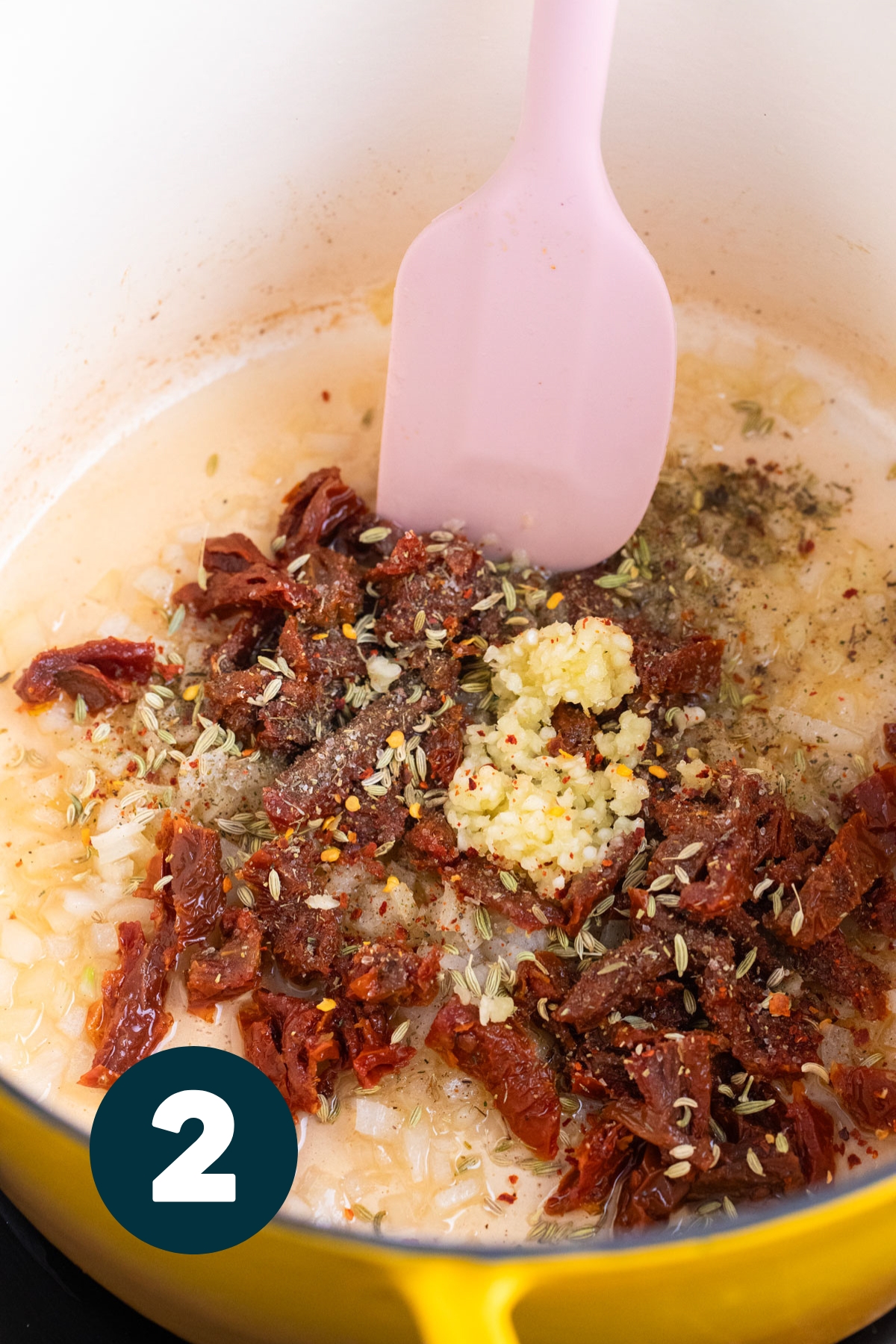 Herbs, garlic, onion and sun dried tomatoes cooking in the soup pot.