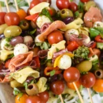 Skewers of bocconcini, tomatoes, sausage slices, olives and basil.