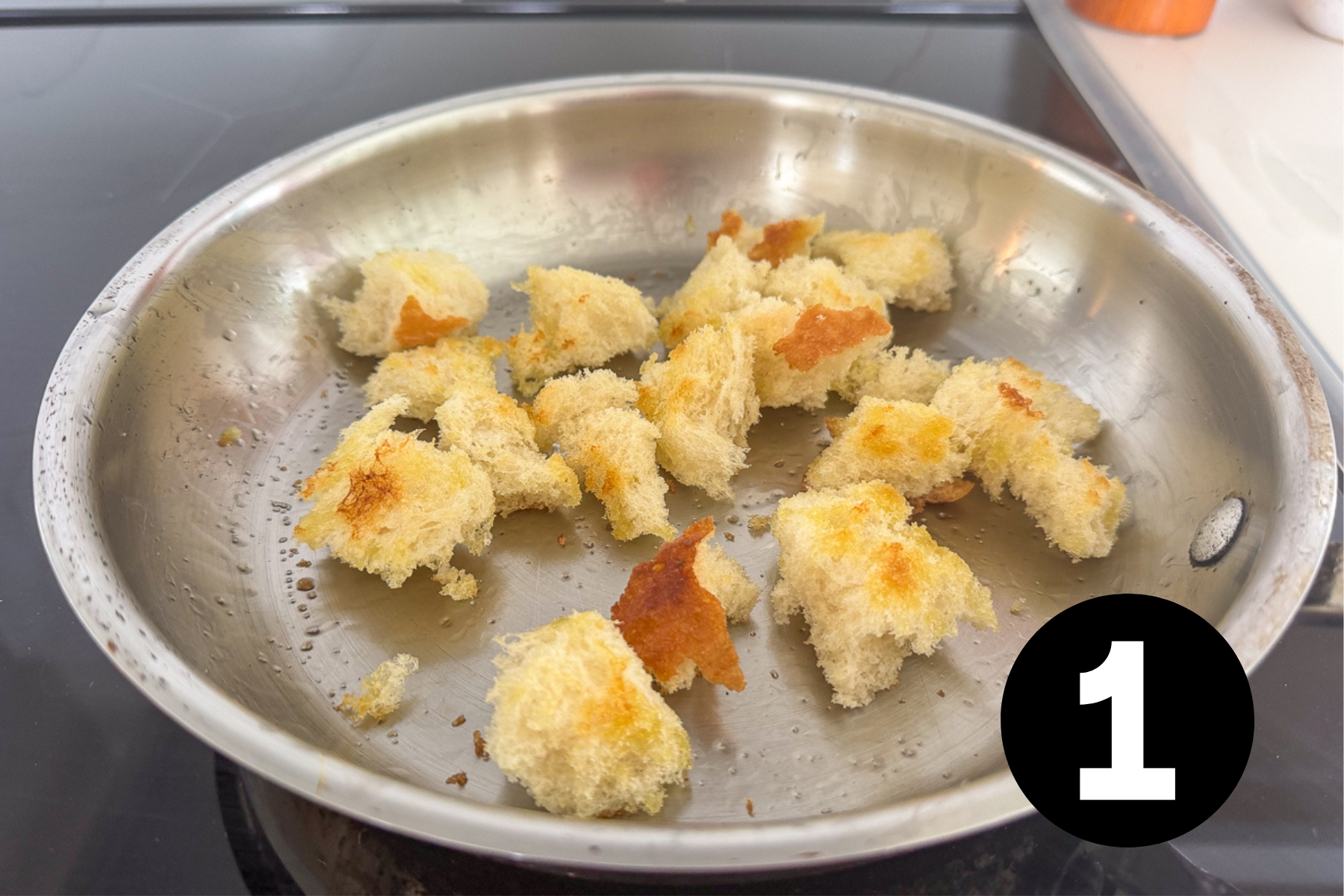 Crispy croutons in a frying pan.