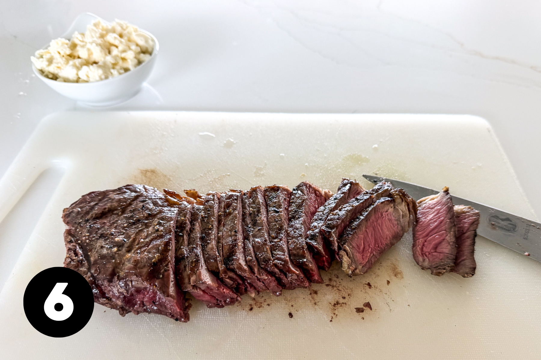 Sliced steak on a cutting board.