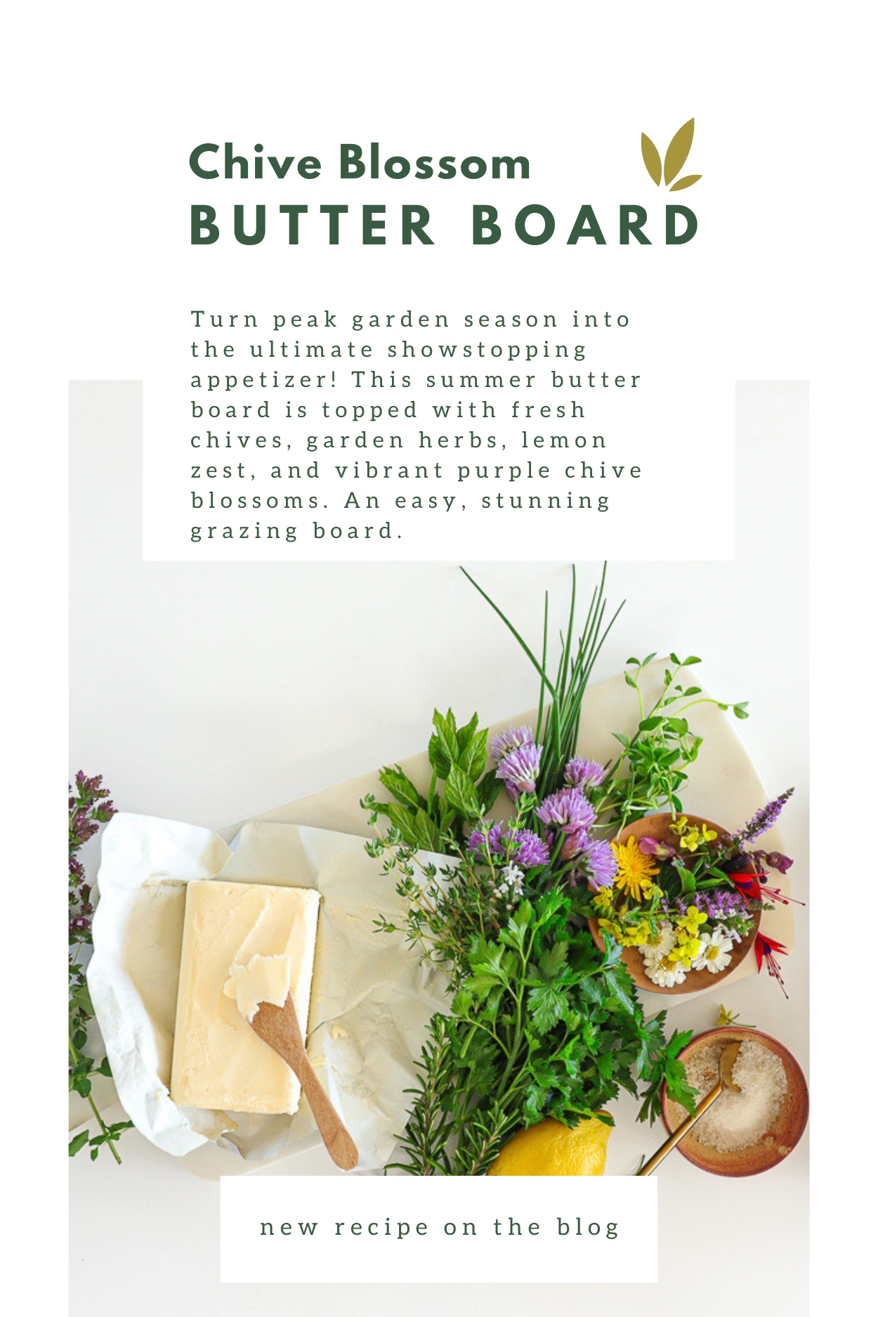 All the ingredients for the butter board on a white marble cutting board including a block of soft butter, chives and chive blossoms and assorted other fresh herbs.