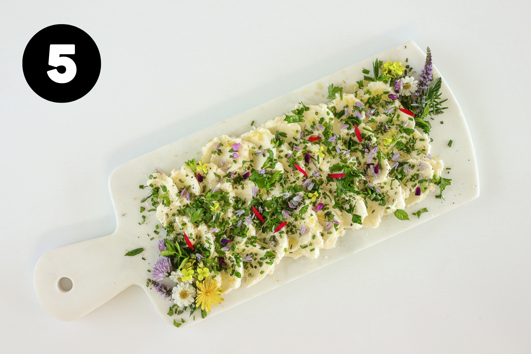 The butter now well sprinkled with chopped herbs and small flower petals.