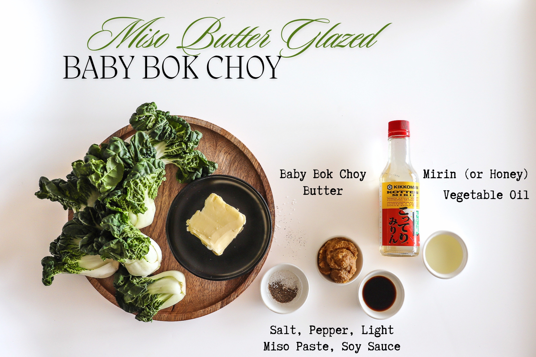 Ingredients for the recipe on a countertop including baby bok choy, butter, mirin, soy sauce, and miso paste.